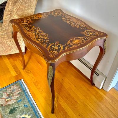 Vtg. Louis XV style table w/ marquetry top and ormolu mounts, excellent condition. Top is approx. 26 x 31” 