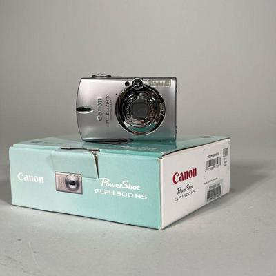 Canon PowerShot ELPH 300 HS | Camera in original box with spare battery and battery charging kit - w. 3.75 x l. 4.75 x d. 1 in

