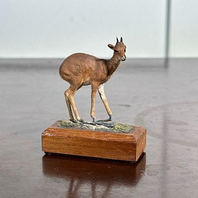 LOUIS PAUL JONAS DEER FIGURINE | Miniature deer figurine on wood base by Louis Paul Jonas Studios, signed on underside. - h. 2.5 x w. 1 x...