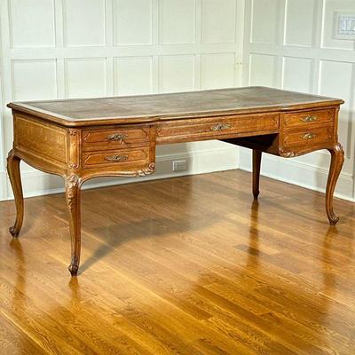 VINTAGE CARVED OAK EXECUTIVE’S DESK | With five drawers to one side, and with faux drawers on the front, inset leather top over carved...