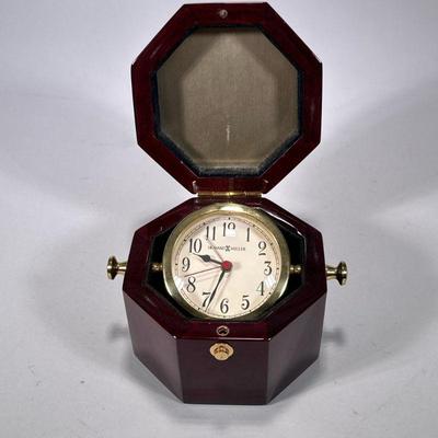 HOWARD MILLER OCTAGONAL WOOD BOX CLOCK | Model 645-187, in a nicely figured wooden box - h. 4 x w. 7 x d. 6 in

