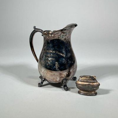 (2pc) SILVER-PLATE ITEMS | Including: Engraved silver-plate pitcher marked on bottom “1779 Silverplate” and Ronson silver plate lighter...