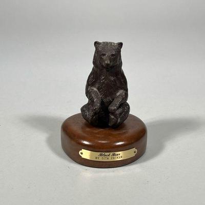 GITA PACKER BRONZE BLACK BEAR | “Black Bear” bronze statue by Gita Packer on wood base with brass plaque. - h. 4.5 x dia. 3.75 in

