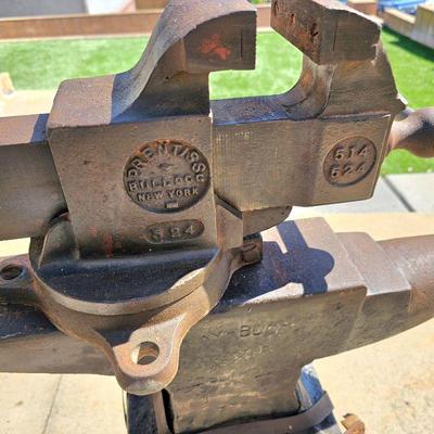 Big vintage Prentiss Bulldog (New York) bench vise. Large, heavy vintage anvil strapped on an old block of wood.