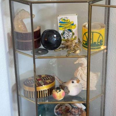 Glass display cabinet full of trinkets