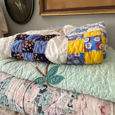 assortment of quilts