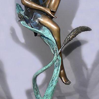 bronze girl on leaf sculpture