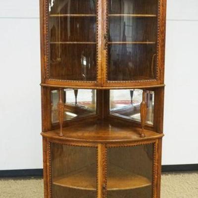 1152	OAK CURVED GLASS CURIO CORNER CABINET, 4 DOOR W/BEVELED MIRROR CENTER, 3 AJUSTALBE SHELVES, APPROXIMATELY 26 IN X 34 IN X 84 IN HIGH
