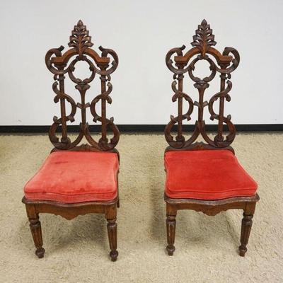 1117	PAIR OF ANTIQUE CARVED OAK GOTHIC STYLE CHAIRS W/LIFT SEATS, EACH APPROXIMATELY 51 IN HIGH
