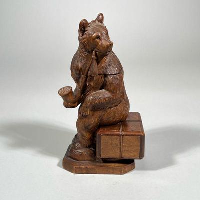 SMOKING BEAR BOX | Carved wood smoking bear figure seated on wood box with opening. - h. 9 x w. 3 x l. 5 in

Contact All Country Estate...