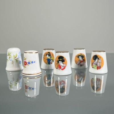 (6pc) PORCELAIN THIMBLES | Including a set of four geisha-decorated thimbles with gilt tops and two English porcelain / bone china...