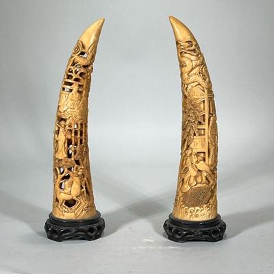 (2pc) JAPANESE DECORATIVE CARVINGS | Resin, faux bone carved horns depicting figures, dragon, and flowers on carved wood stands. - h....