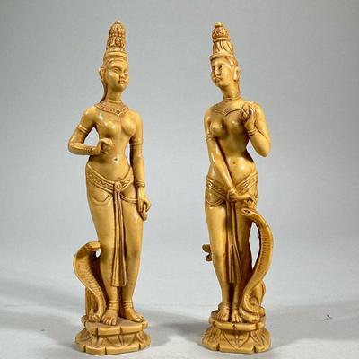 (2pc) CARVED ASIAN FIGURES | Resin, faux bone, carved female figures with snakes, one with a lion and the other with an elephant, each on...