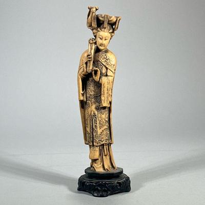 CARVED ASIAN FIGURE | Faux bone carved Asian figure depicting woman playing an instrument on carved wood base. - h. 13 x w. 4 x d. 3.5...