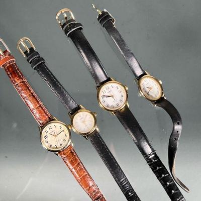 (4pc) Lady's Timex Wristwatches | Including two Timex Indiglio WR 30M watches, one on a brown leather band, the others on black leather...