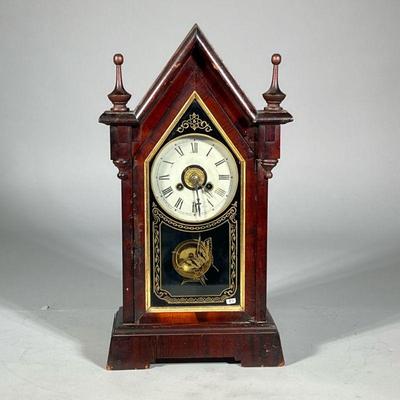 WOODEN STEEPLE-FORM SHELF CLOCK | The face with Roman numeral markers within a steepled burlwood case with gilt decorated glass with...