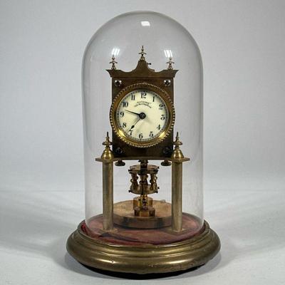 GLASS DOMED "ANNIVERSARY" CLOCK | Glass domed brass clock with ceramic face marked "Anniversary Trade Mark...