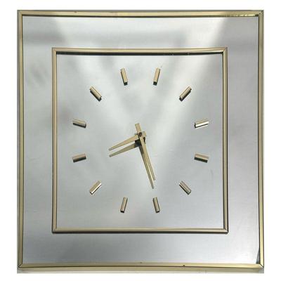 MID-CENTURY MIRRORED CLOCK | Mid-century modern brass and mirror wall clock, displays at an angle. - h. 18 x w. 18 in

Contact All...