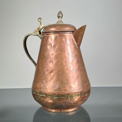 HAMMERED COPPER PITCHER | With hinged lid. - h. 9 x l. 6.5 in

Contact All Country Estate Sales
