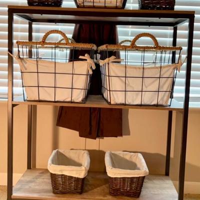 Three tier storage rack with wire and wicker baskets for storage.