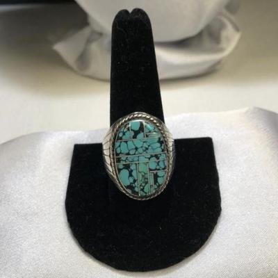 Lot # : 137 - Man's Silver Ring
Turquoise colored center with inlaid metal designs weighs 21.5 grams of tested silver and is size 11.
