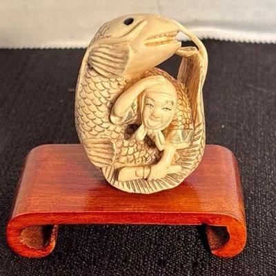 Antique japanese netsuke fish wrapped person