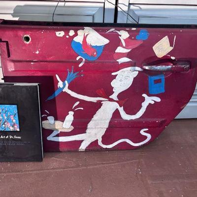 Painting of dr seuss on jeep door w book