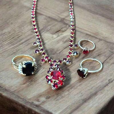 Garnet rings complementing necklace