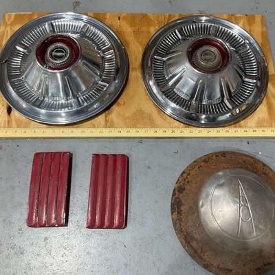 Vintage car parts collection includes hubcaps