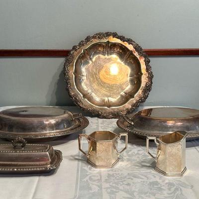 (6pc) Silver Plate Serving Pieces | Assortment of silver plate serving pieces including a creamer and sugar bowl, lidded dishes and trays.

