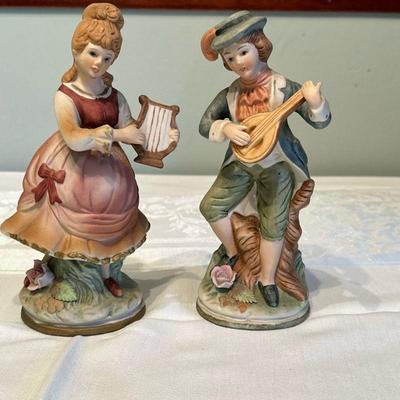 (2pc) Figurines - Two Musicians | Pair of hand-painted porcelain musician figurines, one with a harp and the other with a string...