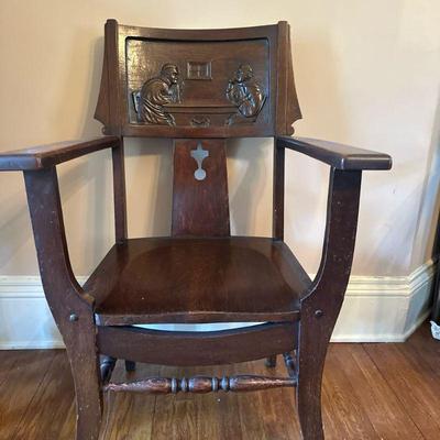 Carved Monk Armchair - 1 of 2 | Antique carved oak armchair featuring back panel artwork of two men at a table. - h. 39.5 x w. 25 x d....