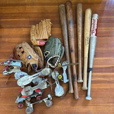 Baseball Equipment & Roller Skates | Vintage sporting equipment including baseball bats, Spalding gloves, and metal clip-on roller...