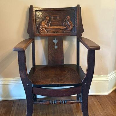 Carved Monk Armchair - 2 of 2 | Antique carved oak armchair featuring back panel artwork of two men at a table. - h. 38 x w. 24 x d. 21.5...