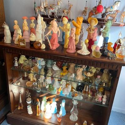 Cabinet filled with Avon perfumes and colognes - vintage.