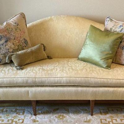 Camelback damask settee with rolled arms