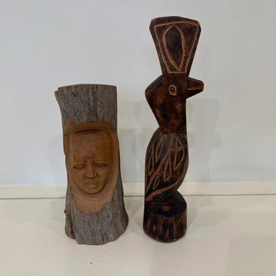 (2pc) Wood Carvings | Carving of a man's face (h. 9 in. x w. 4 in.) Tribal-inspired bird (h. 12 in. x w. 2.5 in.)


