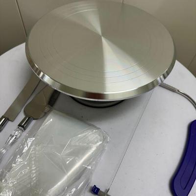 Rotating Cake Stand | Rotating cake stand for decorating (new in box) with piping bags and pie servers. - h. 5 x dia. 12 in (cake stand)