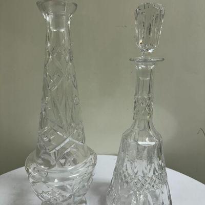 (2pc) Crystal Decanters | Vintage cut crystal decanters with crystal stoppers. Taller decanter: h. 18.5 in. Shorter decanter: h. 13.5 in.

