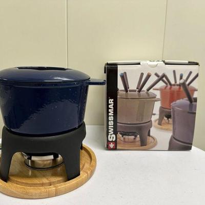 Swissmar Fondue Maker | Swissmar "Sierra" cast iron fondue maker includes: Fondue pot Removable splatter ring. Cast iron stand...