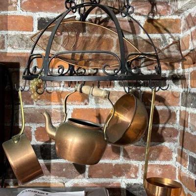 Metal pot rack with copper utensils