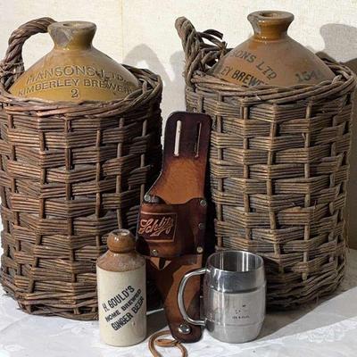 Two stoneware jugs in wicker baskets