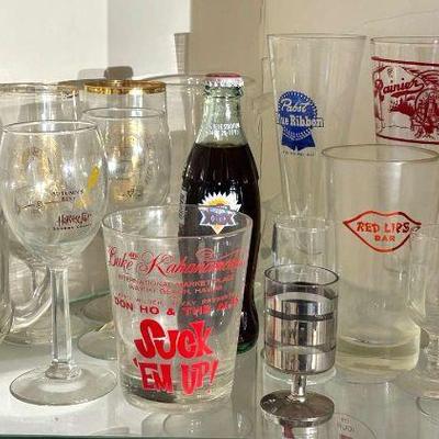 A corner cabinet full of glassware