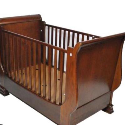 The Simon Horn Crib/Sofa is a beautifully crafted, multifunctional piece that effortlessly transitions from a cozy crib to a stylish sofa.