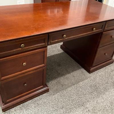 Classic wooden executive desk with brass hardware