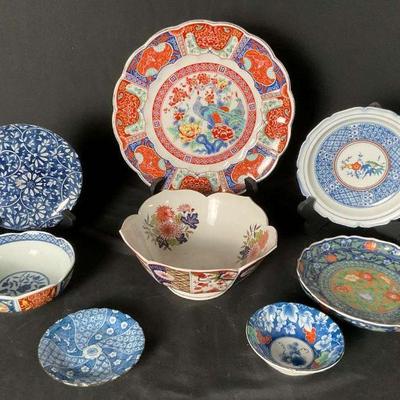 Lot of colorful asian inspired decorative plates and bowls
