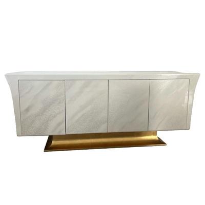 MODERN LACQUERED CONSOLE | Contemporary style credenza / sideboard cabinet in a lacquered faux marble with curved sides over a gilt base,...