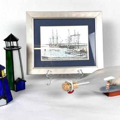 Lot #82 Vintage Two Ships in a bottle with Lighthouse, 2 Stained Glass Lighthouses, and Framed Nautical Artwork
