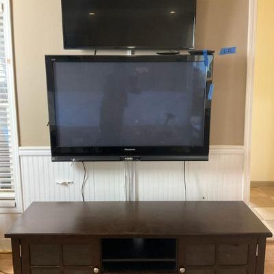 Dark wood entertainment center with 2 tvs