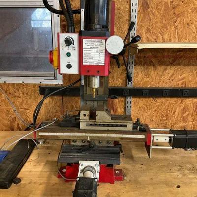 Benchtop milling machine on wooden workbench